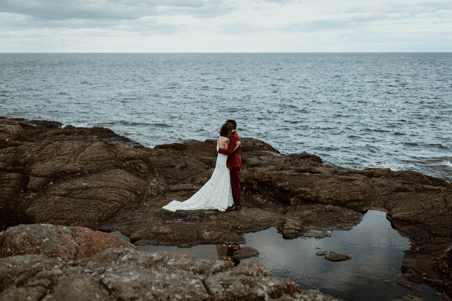 Bride and groom at the black rocks on Preque Isle in Marquette.