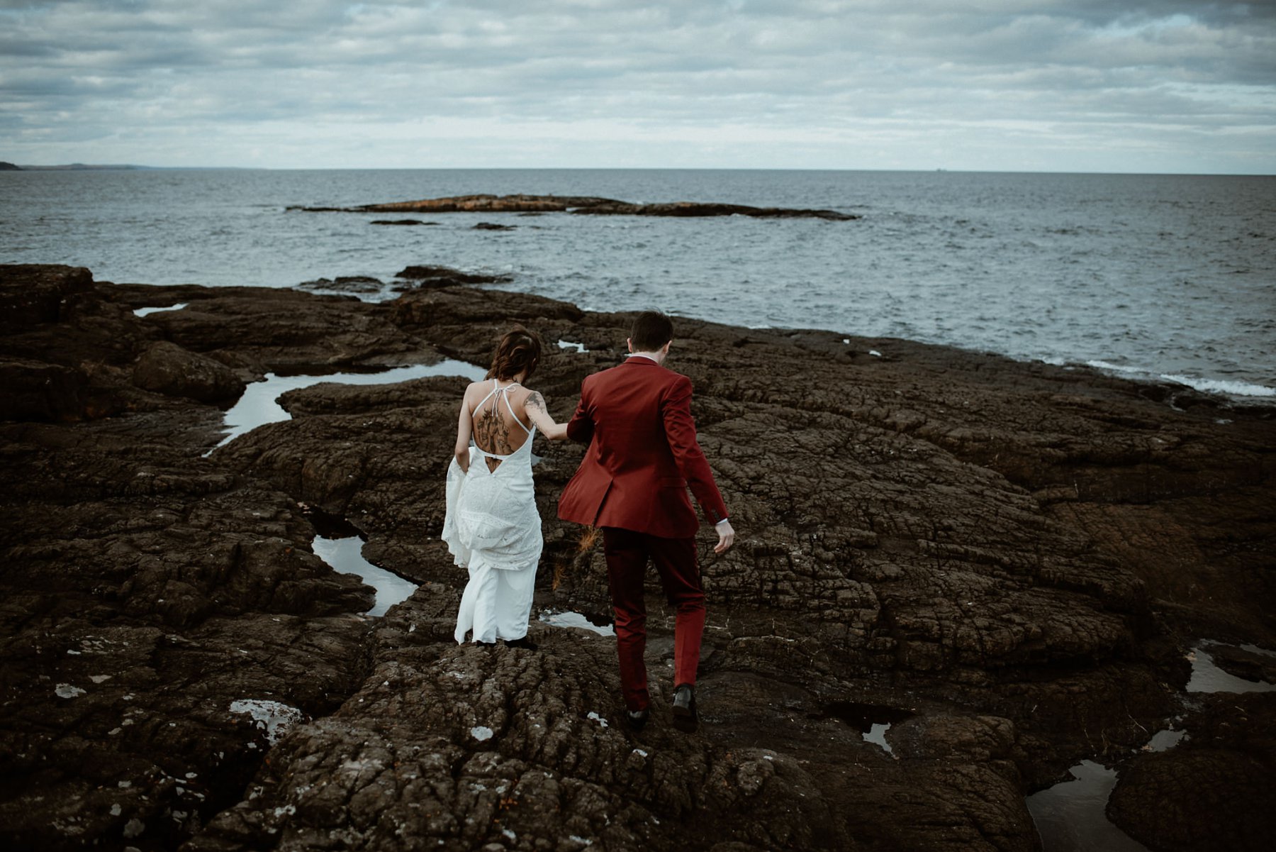 Bride and groom at the black rocks on Preque Isle in Marquette.