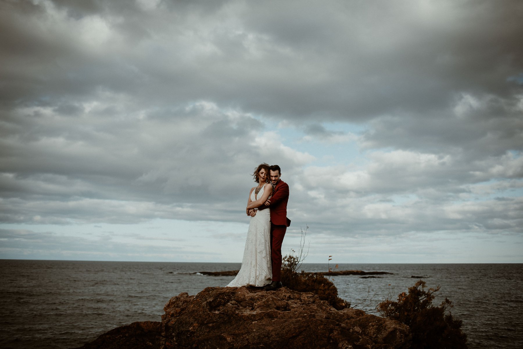 Bride and groom at the black rocks on Preque Isle in Marquette.