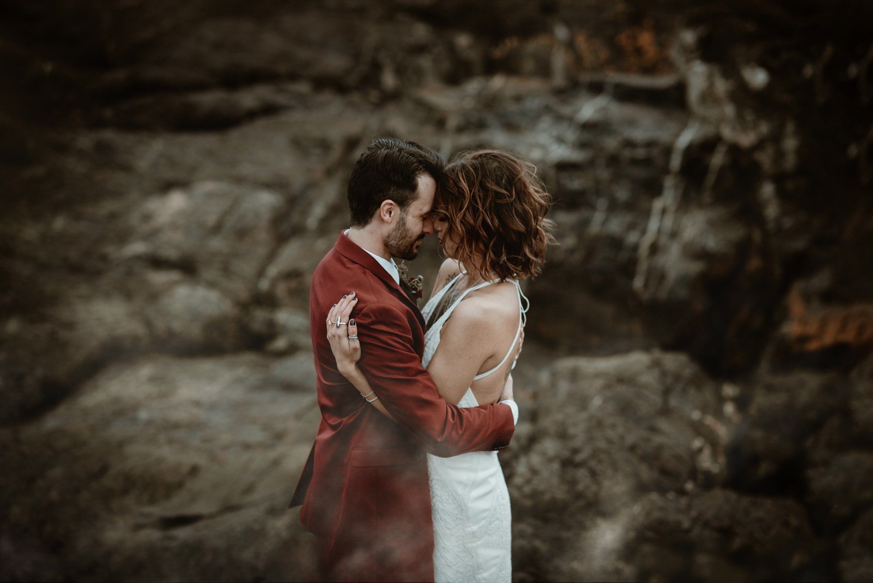 Bride and groom embracing at the black rocks in Marquette, MI.