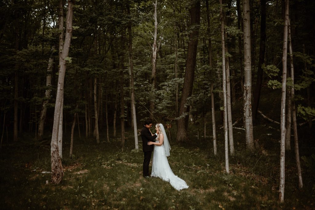 A bride and groom elope in Michigan in the forest.