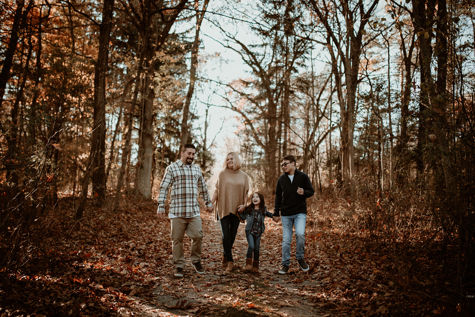 Family walking in the woods in fall