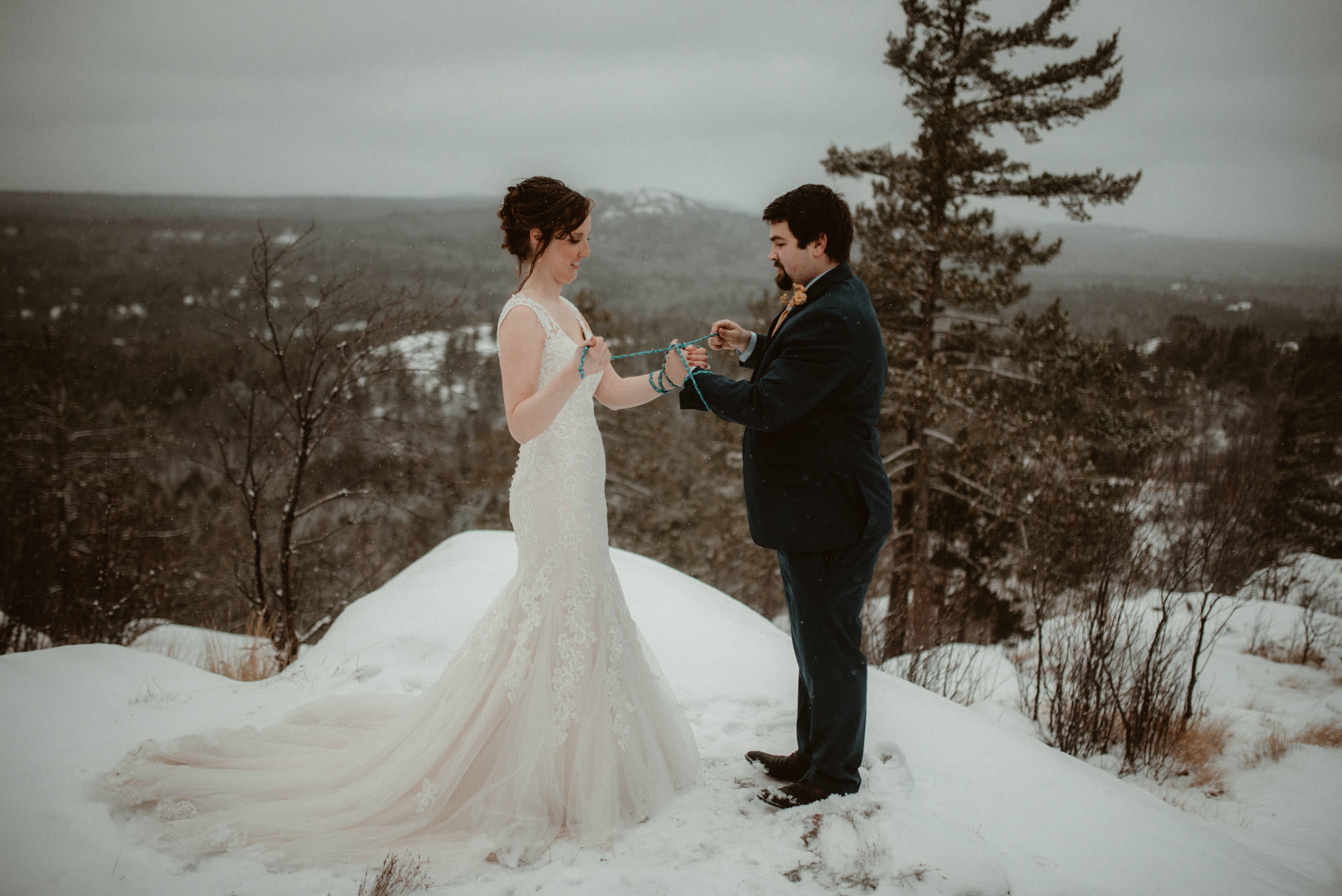 Handfasting ceremony at elopement on Sugarloaf Mountain in Marquette, MI