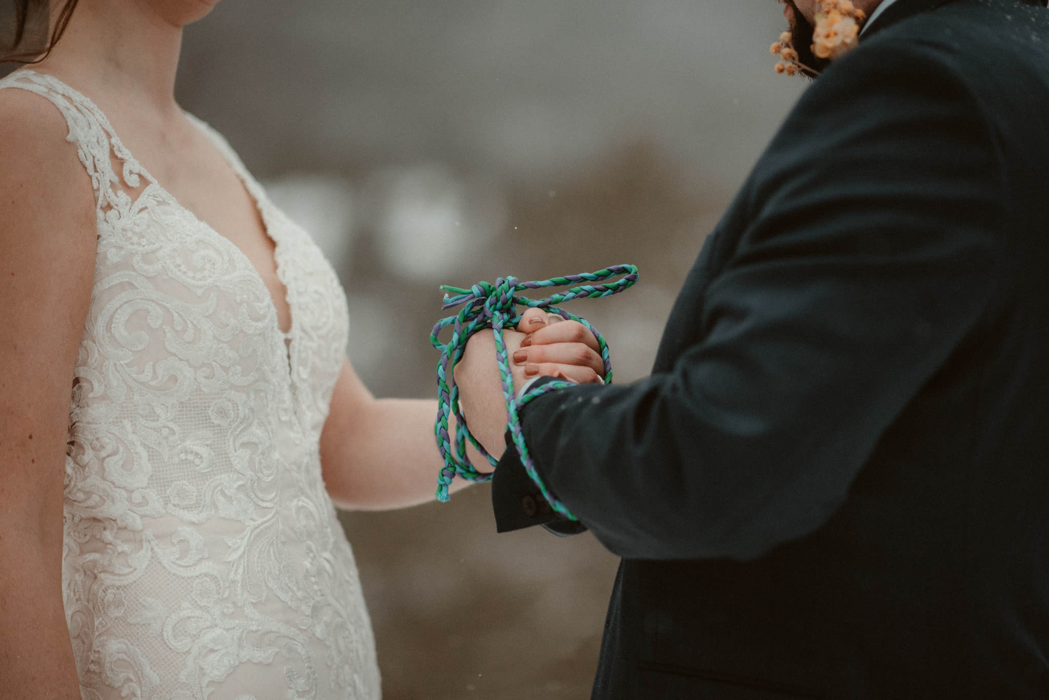 Handfasting ceremony at elopement on Sugarloaf Mountain in Marquette, MI