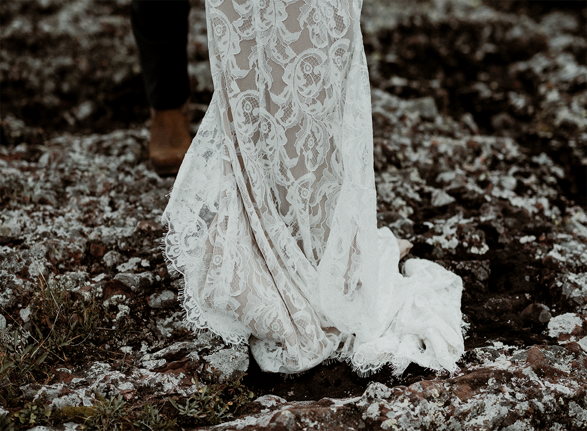 Wedding dress blowing on rocks