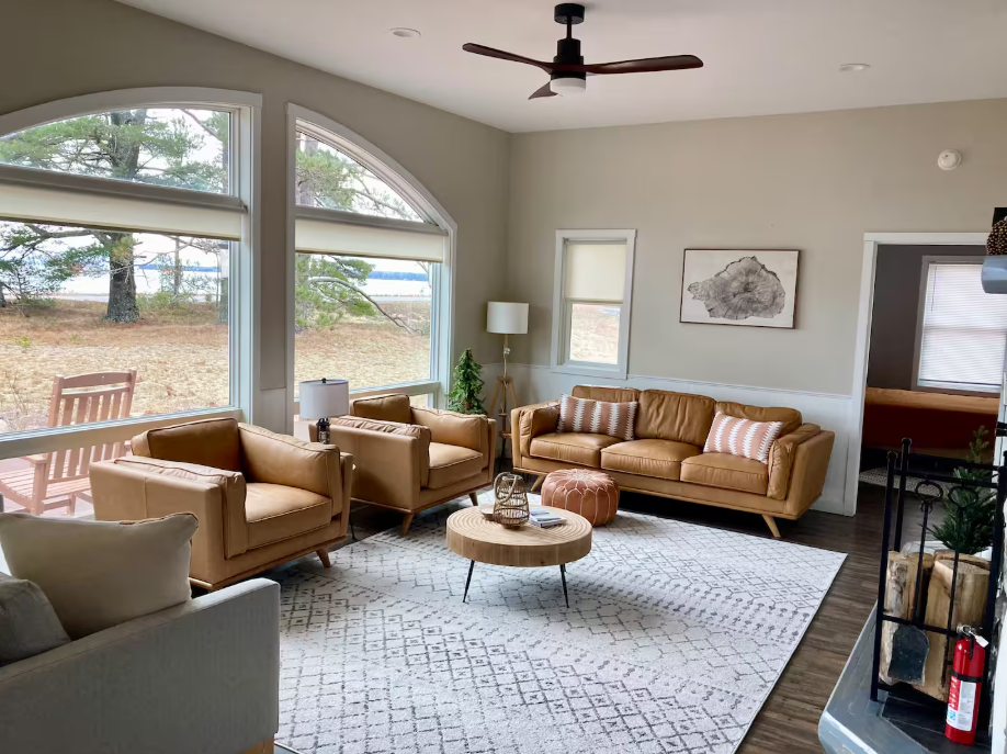 Interior photo of a modern boho living room with lots of window light and a view of lake superior in Bete Gris.