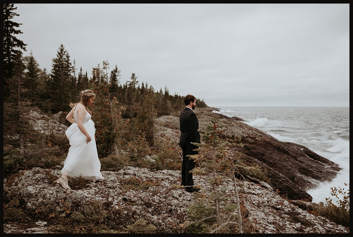 Bride and groom doing a first look on the rocky coast of Lake Superior.