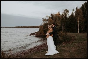 Bride and Groom watching the sunset over Lake Superior at their wedding in Copper Harbor, Michigan.