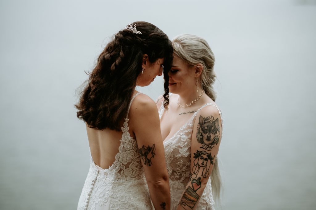 Two brides sharing a moment at their Marquette MI Elopement