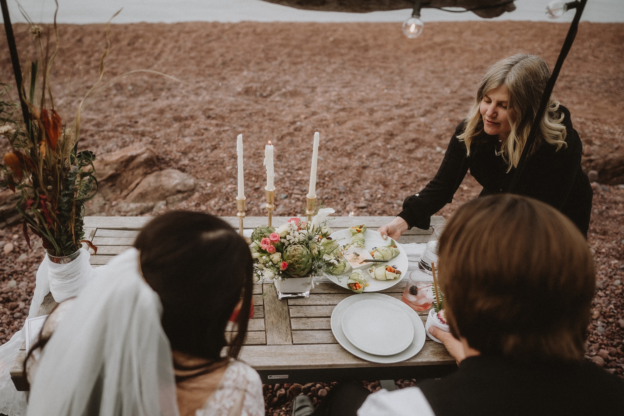 A private chef seving food at an elopement in Copper Harbor Michigan